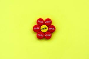 Flower of many red caps with coca cola logo on yellow background photo