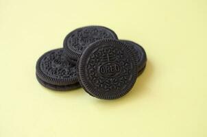 Many OREO sandwich cream biscuits on yellow background photo