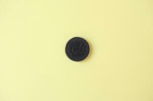 One OREO sandwich cream biscuits on yellow background photo