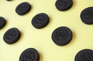 Many OREO sandwich cream biscuits on yellow background photo