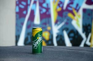 Sprite classic drink can on blurred colorful background outdoors photo