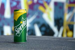 Sprite classic drink can on blurred colorful background outdoors photo