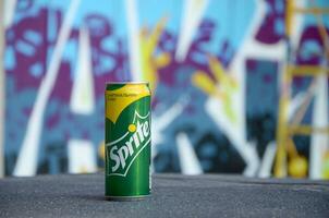 Sprite classic drink can on blurred colorful background outdoors photo