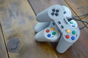 Dendy video game console classic controllers on a wooden table photo