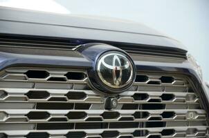 Toyota logo in silvery car front part close up outdoors photo