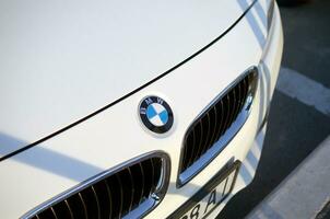 Front view of white BMW car with company logo photo