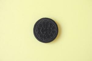 One OREO sandwich cream biscuits on yellow background photo