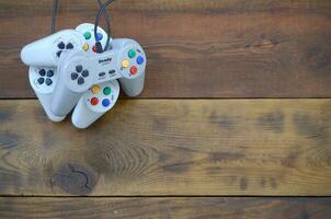 Dendy video game console classic controllers on a wooden table photo