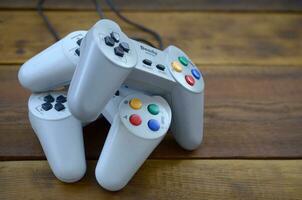 Dendy video game console classic controllers on a wooden table photo