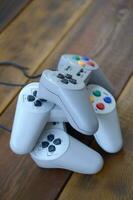 Dendy video game console classic controllers on a wooden table photo