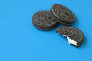 Many OREO sandwich cream biscuits on blue background photo