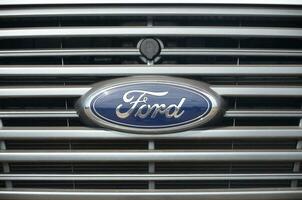 Ford logo in blue car front part close up outdoors photo