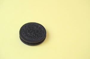 One OREO sandwich cream biscuits on yellow background photo