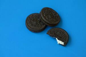 Many OREO sandwich cream biscuits on blue background photo