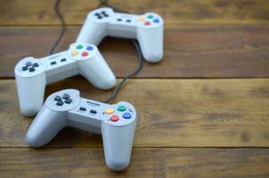 Dendy video game console classic controllers on a wooden table photo