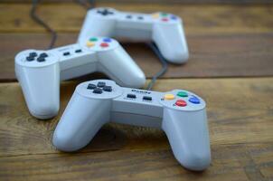 Dendy video game console classic controllers on a wooden table photo