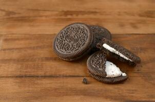 Many OREO sandwich cream biscuits on wooden background photo