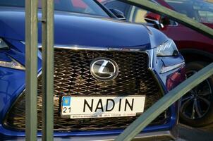 Lexus NX 300h front part with company logo and name NADIN on license plate number photo