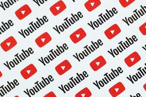 Youtube pattern printed on paper with small youtube logos and inscriptions. YouTube is Google subsidiary and American most popular video-sharing platform photo