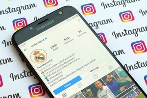 Real Madrid official instagram account on smartphone screen on paper instagram banner. photo