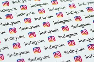 Instagram pattern printed on paper with small instagram logos and inscriptions. Instagram is American photo and video-sharing social networking service owned by Facebook