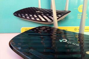 Wireless router modem tp link Archer C20 AC750 and colored cardboard box with tp-link logo photo