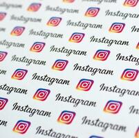 Instagram pattern printed on paper with small instagram logos and inscriptions. Instagram is American photo and video-sharing social networking service owned by Facebook