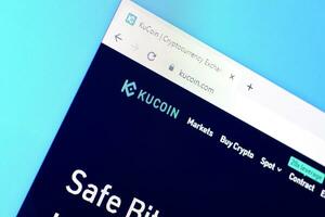 Homepage of kucoin website on the display of PC, url - kucoin.com. photo