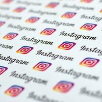 Instagram pattern printed on paper with small instagram logos and inscriptions. Instagram is American photo and video-sharing social networking service owned by Facebook