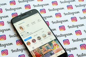 Katy Perry official instagram account on smartphone screen on paper instagram banner. photo