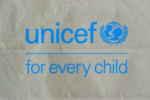 Unicef blue logo on brown paper bag, United Nations Childrens Fund is agency responsible for providing humanitarian and developmental aid to children around the world photo