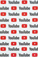 Youtube pattern printed on paper with small youtube logos and inscriptions. YouTube is Google subsidiary and American most popular video-sharing platform photo