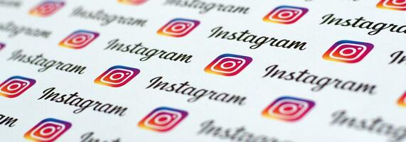 Instagram pattern printed on paper with small instagram logos and inscriptions. Instagram is American photo and video-sharing social networking service owned by Facebook