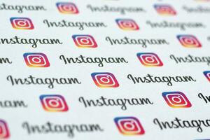 Instagram pattern printed on paper with small instagram logos and inscriptions. Instagram is American photo and video-sharing social networking service owned by Facebook