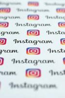 Instagram pattern printed on paper with small instagram logos and inscriptions. Instagram is American photo and video-sharing social networking service owned by Facebook