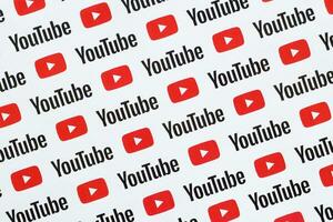 Youtube pattern printed on paper with small youtube logos and inscriptions. YouTube is Google subsidiary and American most popular video-sharing platform photo