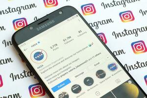 Nasa official instagram account on smartphone screen on paper instagram banner. photo