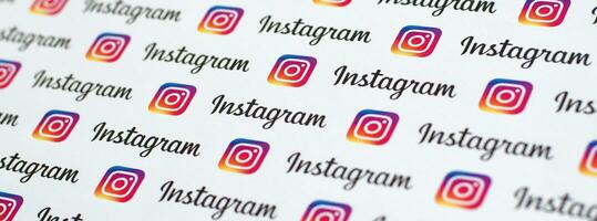 Instagram pattern printed on paper with small instagram logos and inscriptions. Instagram is American photo and video-sharing social networking service owned by Facebook