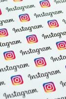 Instagram pattern printed on paper with small instagram logos and inscriptions. Instagram is American photo and video-sharing social networking service owned by Facebook