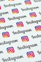 Instagram pattern printed on paper with small instagram logos and inscriptions. Instagram is American photo and video-sharing social networking service owned by Facebook