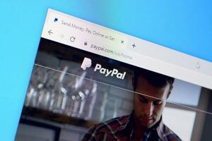 Homepage of paypal website on the display of PC, url - paypal.com. photo