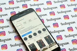 Dolce and Gabbana official instagram account on smartphone screen on paper instagram banner. photo