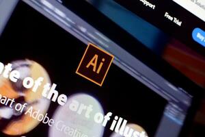 Web page of adobe illustrator product on official website on the display of PC photo