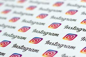 Instagram pattern printed on paper with small instagram logos and inscriptions. Instagram is American photo and video-sharing social networking service owned by Facebook