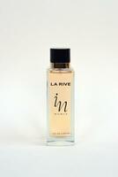 La rive IN woman perfume bottle on beige background. LA RIVE S.A. is one of the leading producers of perfumes and perfumed waters in Europe photo