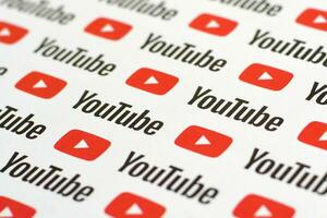 Youtube pattern printed on paper with small youtube logos and inscriptions. YouTube is Google subsidiary and American most popular video-sharing platform photo