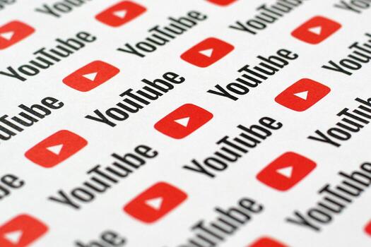 Youtube pattern printed on paper with small youtube logos and inscriptions. YouTube is Google subsidiary and American most popular video-sharing platform photo