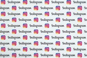 Instagram pattern printed on paper with small instagram logos and inscriptions. Instagram is American photo and video-sharing social networking service owned by Facebook