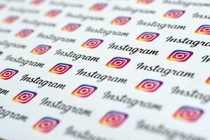 Instagram pattern printed on paper with small instagram logos and inscriptions. Instagram is American photo and video-sharing social networking service owned by Facebook