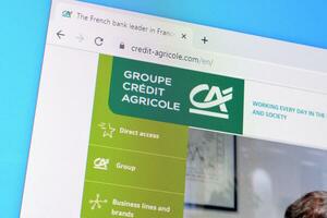 Homepage of credit-agricole website on the display of PC, url - credit-agricole.com. photo